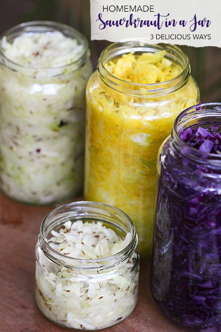 Homemade sauerkraut in a jar 3 different wasy with red cabbage, white cabbage, turmeric, caraway seeds and ginger