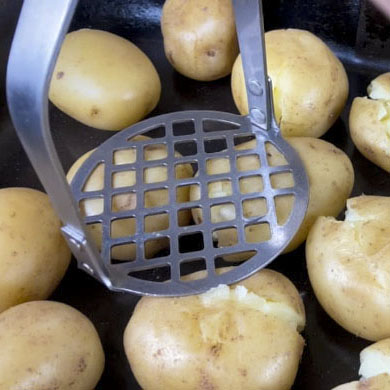 Gently pressing the potatoes before roasting
