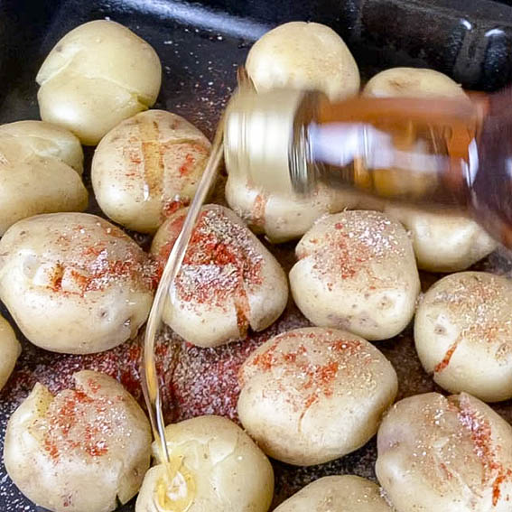 Putting warming spices and a drizzle of oil on the potatoes before roasting