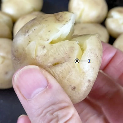 Potato with the skins gently popped open before roasting