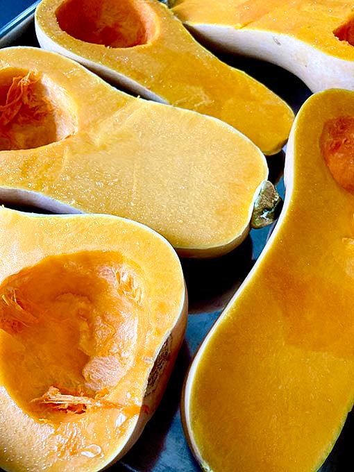 Butternut squash in halves before roasting in the oven