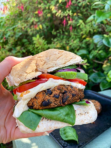My black bean burger in a bun with tomato and avocado