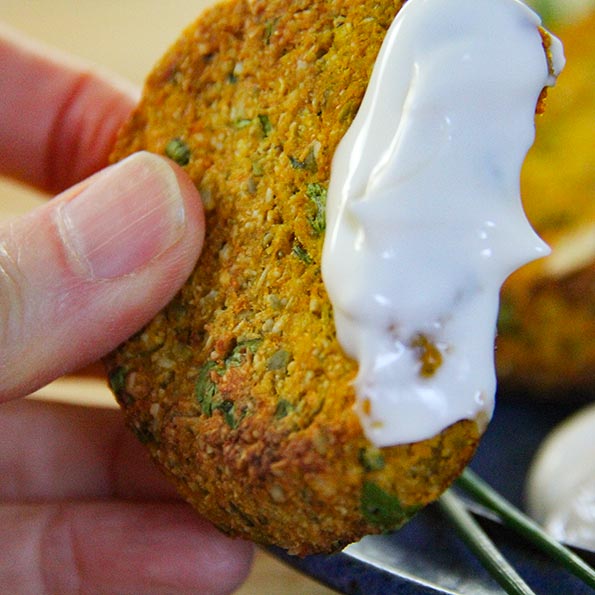 Quinoa squash burgers dipped in vegan mayo