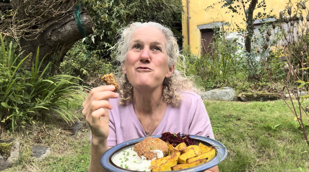 Anastasia eating dulse flake burgers in her garden